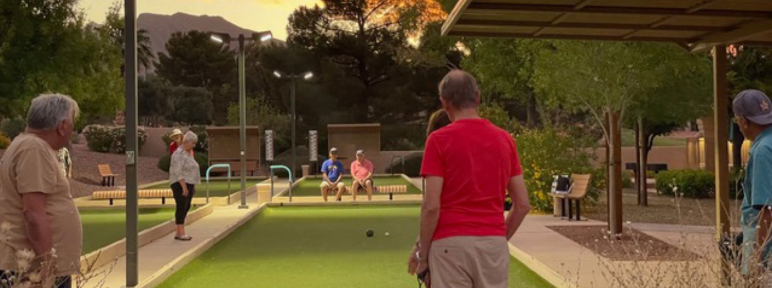 Neighbors playing bocce at sunset