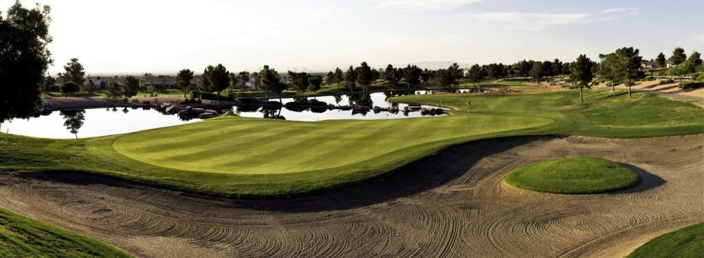 Highland Falls green and water hazard, with desert mountains beyond